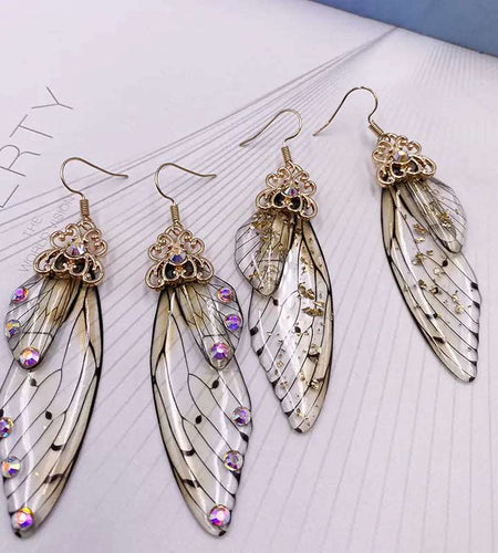 Fairy Wing EarringsIntroducing our newest accessory, the Fairy Wing Earrings! These beautiful earrings are handmade with simulation wings and rhinestone details. They are perfect for aWomens earringsHi Tech Glam LtdFairy Wing Earrings