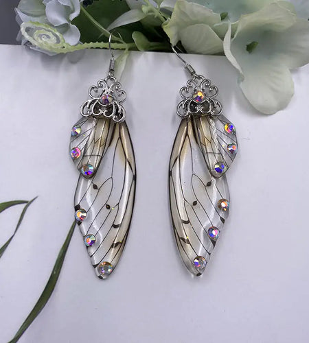 Fairy Wing EarringsIntroducing our newest accessory, the Fairy Wing Earrings! These beautiful earrings are handmade with simulation wings and rhinestone details. They are perfect for aWomens earringsHi Tech Glam LtdFairy Wing Earrings
